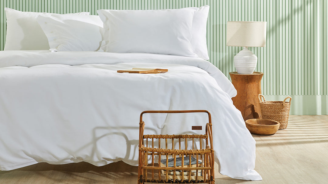 Plain duvet cover set with bed sheet and pillow covers displayed in bedroom